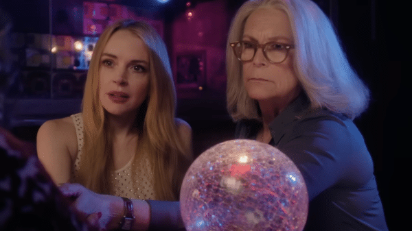 Anna and Tess sitting with a crystal ball, having their fortune told.